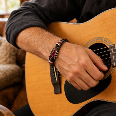Red guitar bracelet worn while strumming an acoustic guitar