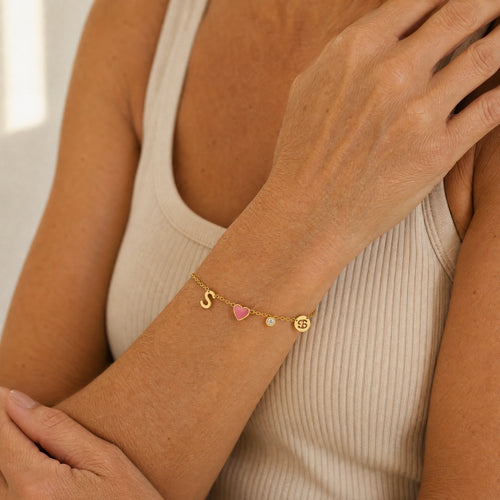 Close-up of the personalized charm bracelet on a woman's wrist