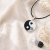 Flat lay of the Yin Yang pendant with howlite and obsidian stones
