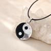Yin Yang pendant resting on a quartz crystal cluster