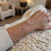 Duo birthstone bracelet worn on a woman's wrist