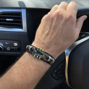 Black guitar bracelet worn while driving