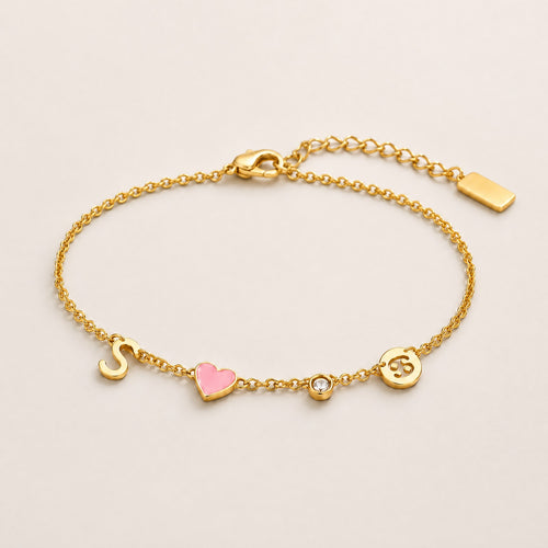 Gold charm bracelet with initial S, pink enamel heart, crystal birthstone and Cancer zodiac coin