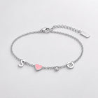 Silver charm bracelet with initial, heart, birthstone and zodiac coin