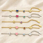 Five personalized charm bracelets in gold and silver with different initials, hearts, birthstones and zodiac signs
