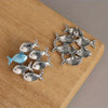 Upstream Fish Stud Earrings — close-up detail view