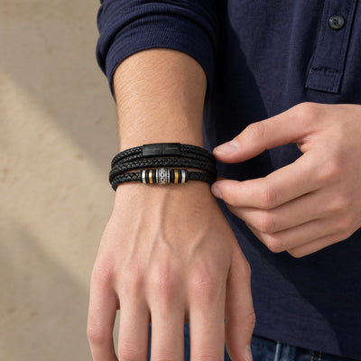 Braided black leather bracelet worn on the wrist