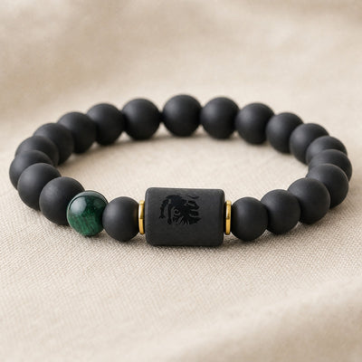 Close-up of the engraved zodiac sign block and accent bead